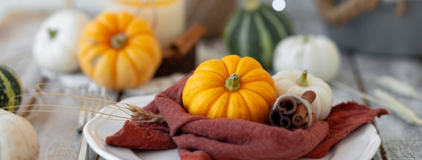 Photo of pumpkins and candle on a wooden table