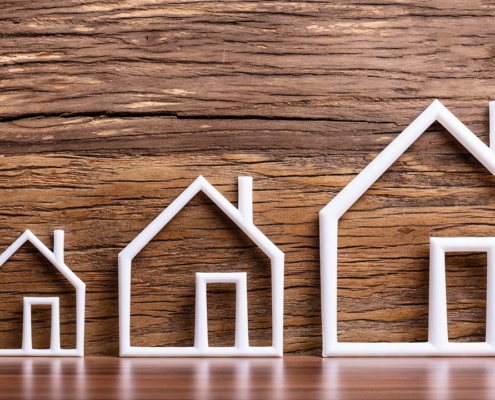 Increasing White Outlined Houses Against Rustic Background