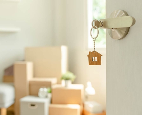 The key was inserted into the door of the new house, inside the room was a cardboard box containing personal belongings and furniture