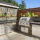 Backyard hardscape entertainment area with built-in kitchen