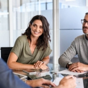 Happy middle aged couple meeting loan advisor to buy a new home