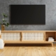 TV and wooden cabinet with gray armchair in modern living room the concrete wall