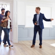 Real estate agent showing a couple around new home