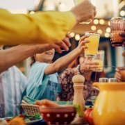 multicultural family and friends gathering together at a backyard party