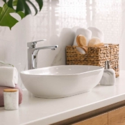 stylish vessel sink on light countertop in modern bathroom