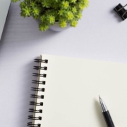 top view of a white desk with laptop and supplies