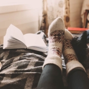 cozy fall day at home with cup of hot tea, book and sleeping dog