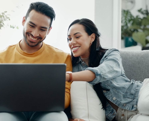 Home laptop, smile and relax couple search internet