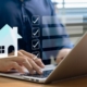 A professional organizing real estate tasks on a laptop using a digital checklist