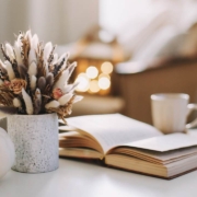 Fall home decoration stock photo with dried flowers, book, and a teacup