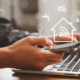 Person using a smart home app on a phone and laptop