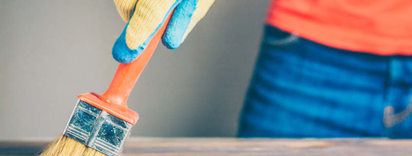 Waxing and oiling with a brush on a wooden table