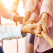 Team of coworker pulling rope together stock photo